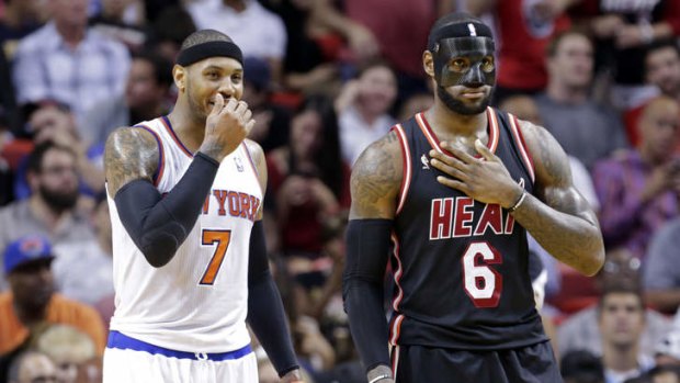 Is that you under there? New York Knicks small forward Carmelo Anthony and Miami Heat small forward LeBron James talk during the game in Miami. The Heat won 108-82.