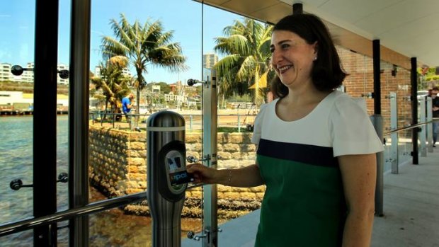 NSW Minister for Transport Gladys Berejiklian holding the Opal card at a tap on/off terminal at Neutral Bay.