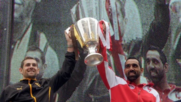 History beckons: Captains Luke Hodge (left) and Adam Goodes hold aloft the premiership cup on the Treasury steps.