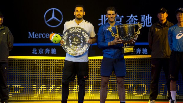Rafael Nadal and Nick Krygios pose with their trophies after the men's singles final match in the China Open.
