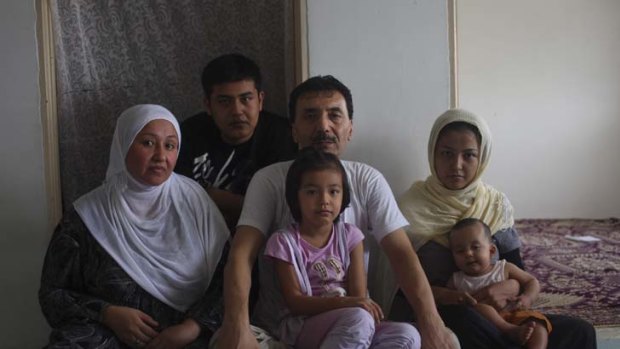 Three generations ... Rajab, an ethnic Hazara refugee who fled Afghanistan in the 1970s, with his wife, children and grandchildren in their flat in Kuala Lumpur.