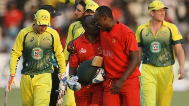 Historic: Zimbabwean batsman Prosper Utseya (left) and his teammate Tendai Chatara celebrate their team's victory over Australia.