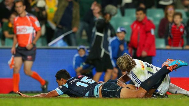 Powerful: Israel Folau scores a try for the Waratahs.