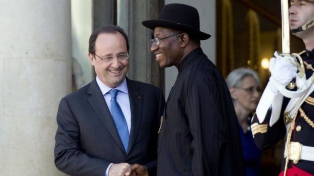 Working together: Nigeria's President Goodluck Jonathan is escorted by French President Francois Hollande as he leaves a Paris summit on the threat from Boko Haram.