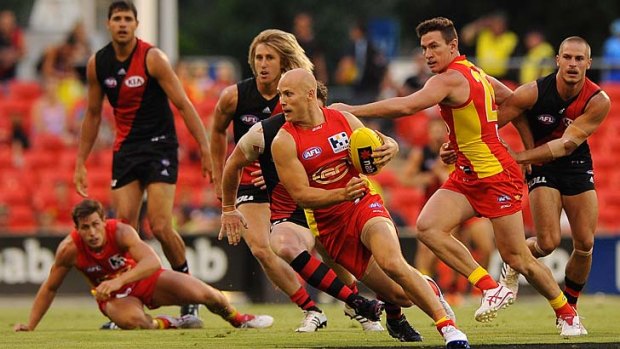 Gary Ablett shows his ability to send would-be tacklers the wrong way at Metricon Stadium on Monday night.