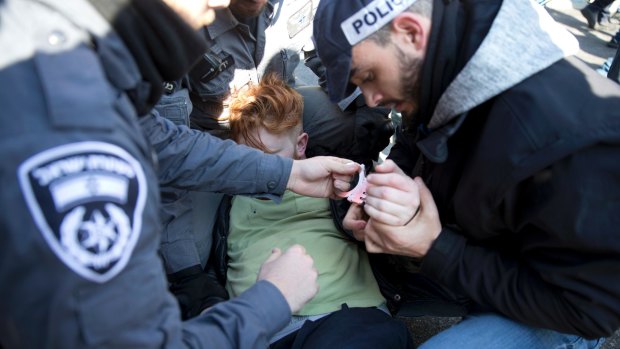 A supporter of Sergeant Elor Azaria is detained by police outside the Israeli military court in Tel Aviv on Wednesday.