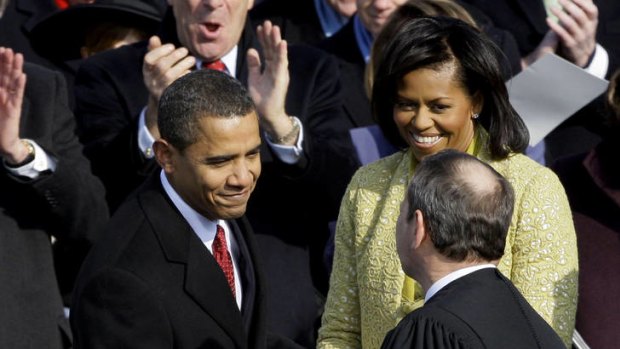 Historic ... Barack Obama shakes hands with Chief Justice John Roberts.