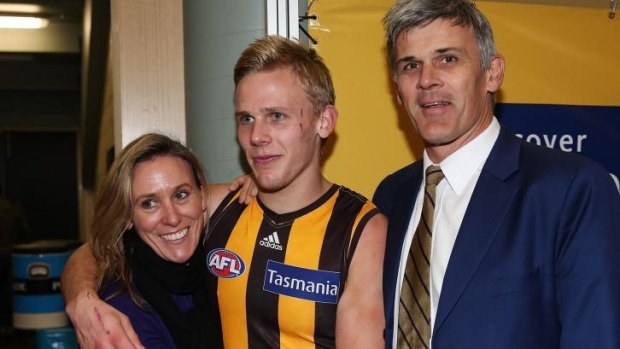 Will Langford celebrates winning his first game with dad Chris (right) and mum Eleanor.