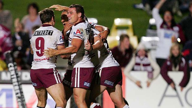 Anthony Watmough of the Sea Eagles celebrates with team mates after a try.