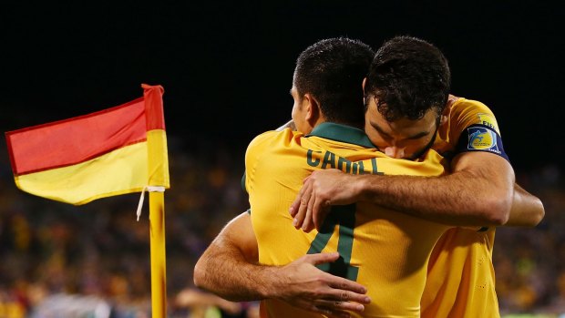 Winning form: Tim Cahill and Mile Jedinak embrace after the striker scored a goal during the 2018 FIFA World Cup qualification match between the Socceroos and Kyrgyzstan in Canberra.