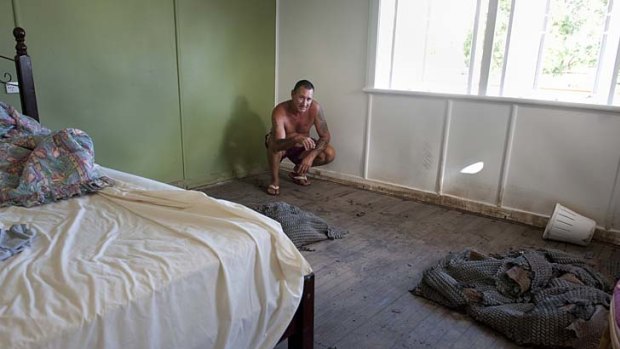 Scott Lyall stands in his recently flooded house in Bundaberg.