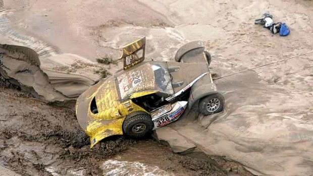 Stuck in the mud ... France's Pascal Thomasse and co-pilot Pascal Larroque are stuck  following a flash flood.