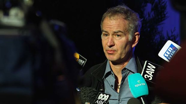 John McEnroe talks to the media after the official draw for the Australian Open.