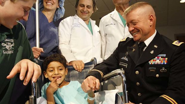 Six-year-old Afghan boy Muslam Hagigshah and US. Army Major Glenn Battschinger re-unite at St. Barnabas Medical Centre.  Battschinger was on patrol in Jalalabad, Afghanistan, when he came across Hagigshah, who was born with his bladder outside his body, and arranged for a doctor in the US to correct the birth defect.