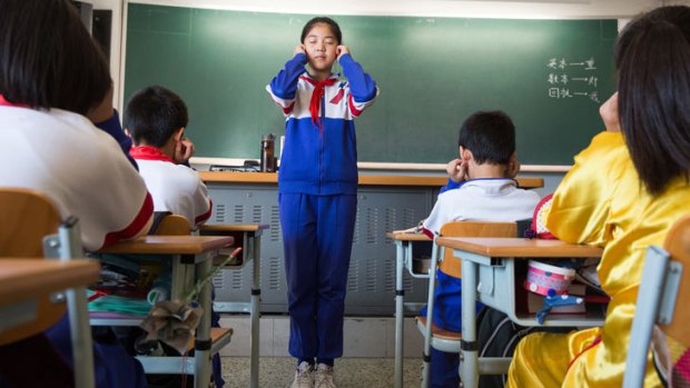 Primary school students at Jingshan School, one of Beijing's most elite schools, do exercises to help relax their eyes.