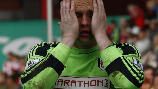 Distraught: Fulham goalkeeper David Stockdale after his side's loss to Stoke City ended their tenure in the Premier League.