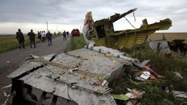 Locals gather near part of the MH17 wreckage near the settlement of Grabovo.