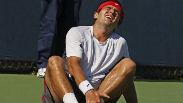 Down and out ... Australia's Marinko Matosevic suffers an ankle injury.