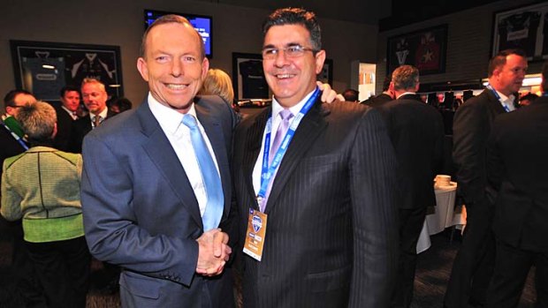 Political animal: AFL CEO Andrew Demetriou with Prime Minister Tony Abbott.