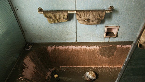 A bathroom covered in dirt and mud in Brisbane after floodwaters receded today. Photo: Jonathan Wood/Getty Images