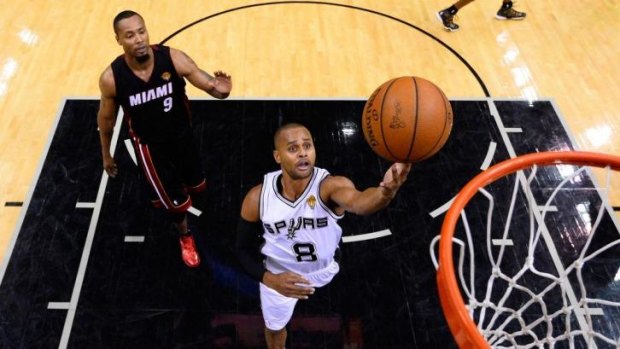 Patty Mills #8 of the San Antonio Spurs goes to the basket.