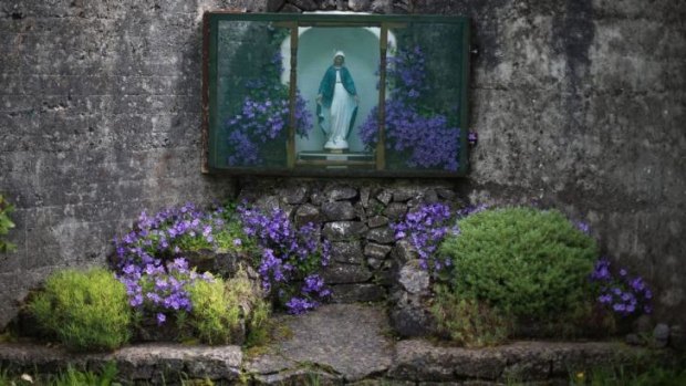 A statue of the Virgin Mary adorns the site of a mass grave for children who died in the Tuam mother and baby home, in Tuam County Galway.