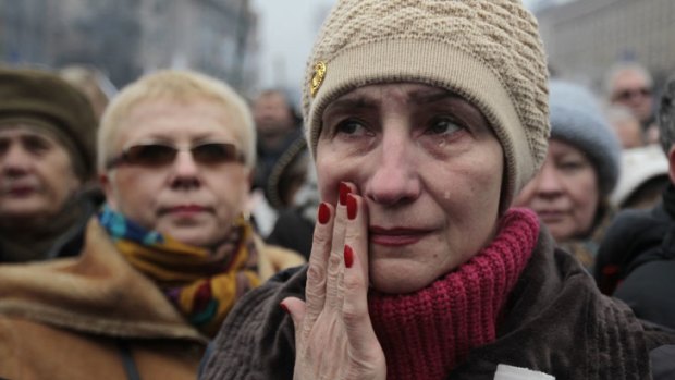 Main picture: A woman wipes away tears at a rally in Kiev's Independence Square at the weekend.