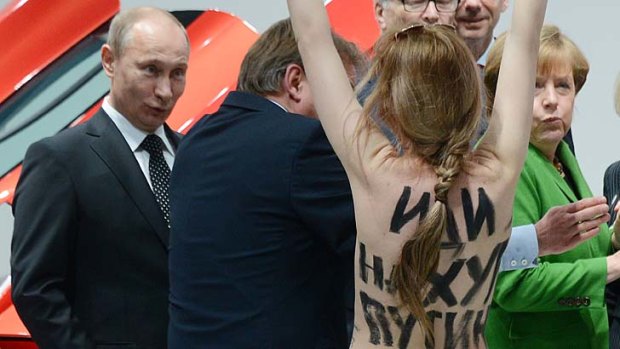 Russian President Vladimir Putin confronted by a topless activist.