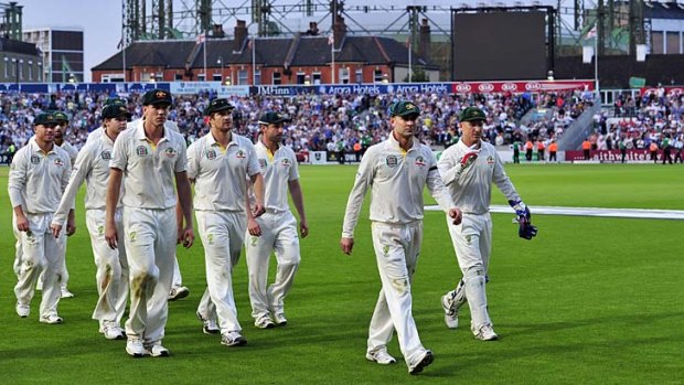 Michael Clarke leads his team off the field after play was stopped for bad light.