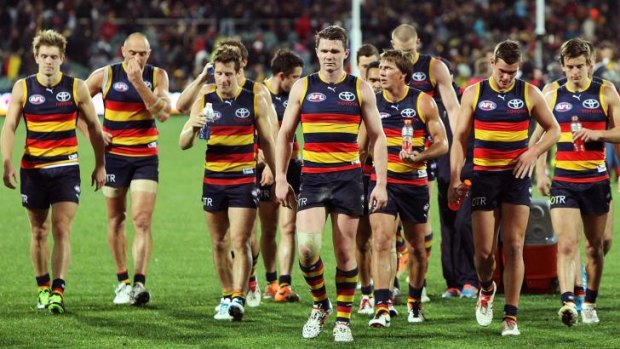 Adelaide players leave the field after their 10-point loss to Richmond on Saturday.