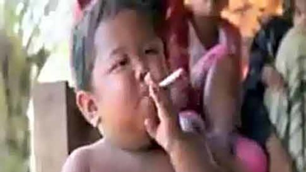 Fagging on ... at the age of two, Ardi Rizal is already a hardened smoker.