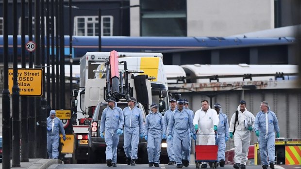 The white van used in the attack is loaded onto a truck on London Bridge.