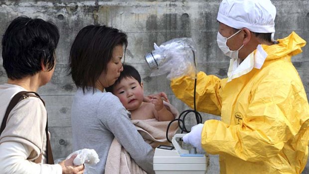 Trying to stay safe ... a one-year-old boy is rechecked for radiation at Nihonmatsu, Fukushima.