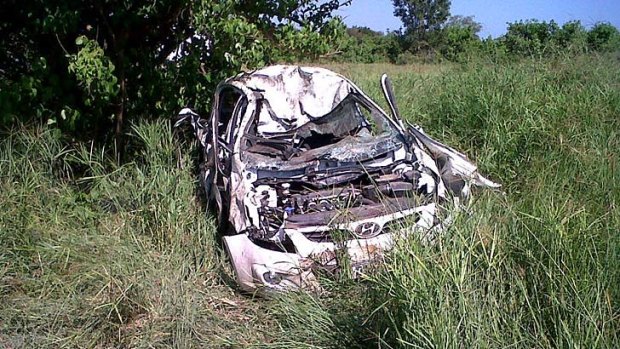The car that was overturned by an elephant lies on the side of the road in the Kruger National Park.