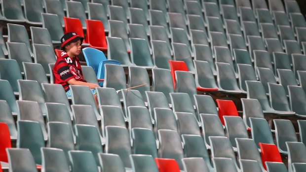 Empty house: A young Wanderers supporter watches on from the empty seats last weekend.