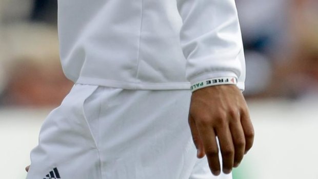 England's Moeen Ali wears a wristband as he fields during the second day of the third cricket test match of the series between England and India at The Ageas Bowl in Southampton, England.