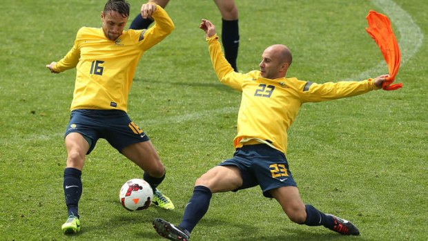 Big penalty: Mark Bresciano challenges during a Socceroos training session on Saturday.