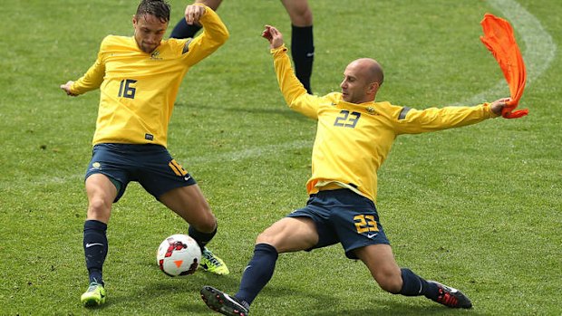 Big penalty: Mark Bresciano challenges during a Socceroos training session on Saturday.