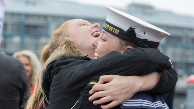 Able Seaman Jordan Shephard gets a wild greeting from cousin Claudia Bush,13 after disembarking from the HMAS Darwin.