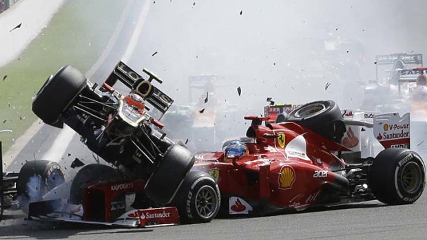 Romain Grosjean crashes with Ferrari's Fernando Alonso in the Belgium Grand Prix last year.