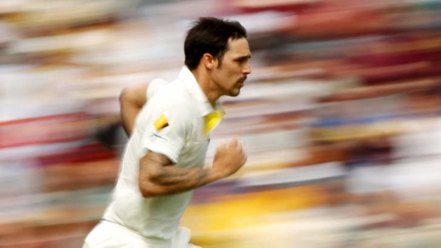 Mitchell Johnson runs in to bowl at the Gabba.
