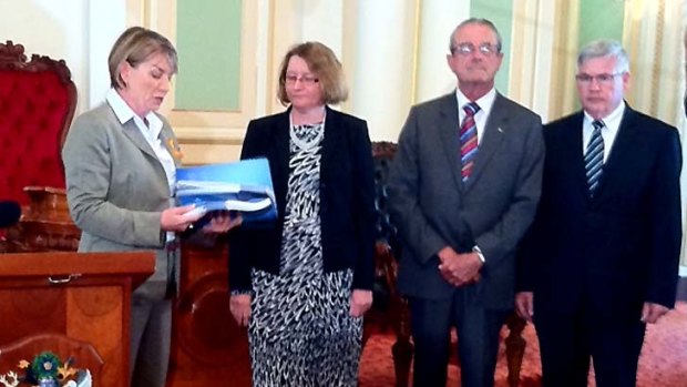 Premier Anna Bligh is handed the Floods Commission of Inquiry's final report.