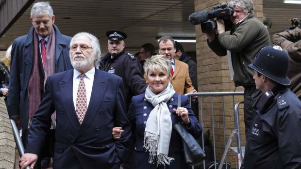 Television and radio personality Dave Lee Travis leaves Southwark Crown Court in London with his wife, Marian Griffin.