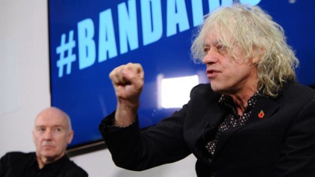 Band Aid 30's Sir Bob Geldof and Midge Ure stand by their song, despite it being labeled 'cringeworthy'.