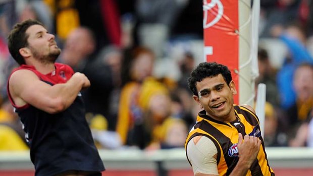 Demon Colin Garland arrives too late to stop Cyril Rioli from notching another goal.