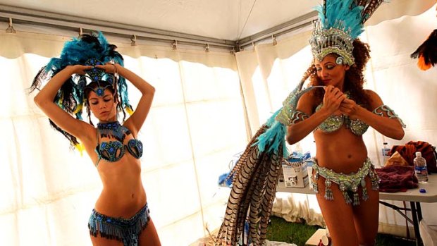 Let the feathers fly: Sequinned Brazilian dancers prepare backstage for the finale of the Autumn Vibes Festival.