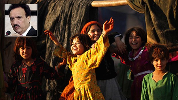 Despite the political crisis engulfing Pakistan, a bunch of Afghan refugee girls find plenty to smile about as they play in a poor neighbourhood in Rawalpindi. Inset: Interior Minister Rehman Malik.