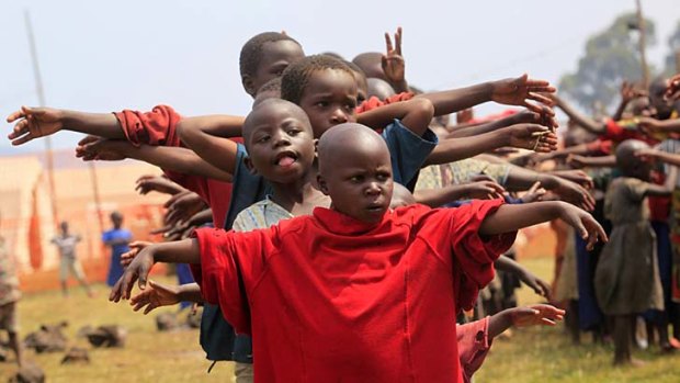 At peace ... refugee children displaced by the fighting play at a transit camp in Uganda.