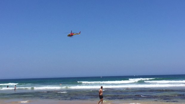 A helicopter conducts a patrol at Point Lonsdale beach on Friday. Several beaches along the Surf Coast have been closed due to shark sightings in the past week.