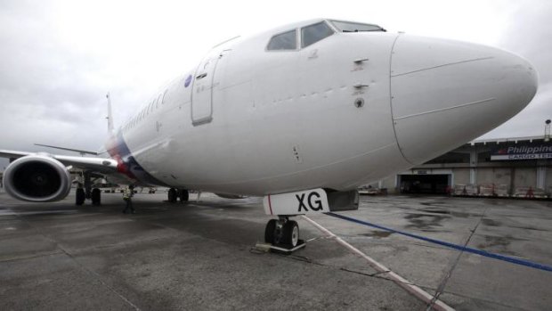 A Malaysian Airlines passenger plane was slightly damaged after it was swept 50 metres away while parked at Ninoy Aquino International Airport during the storm.